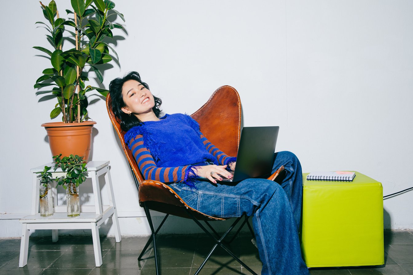 Flash People Portraits Woman Lounging on Chair with Laptop